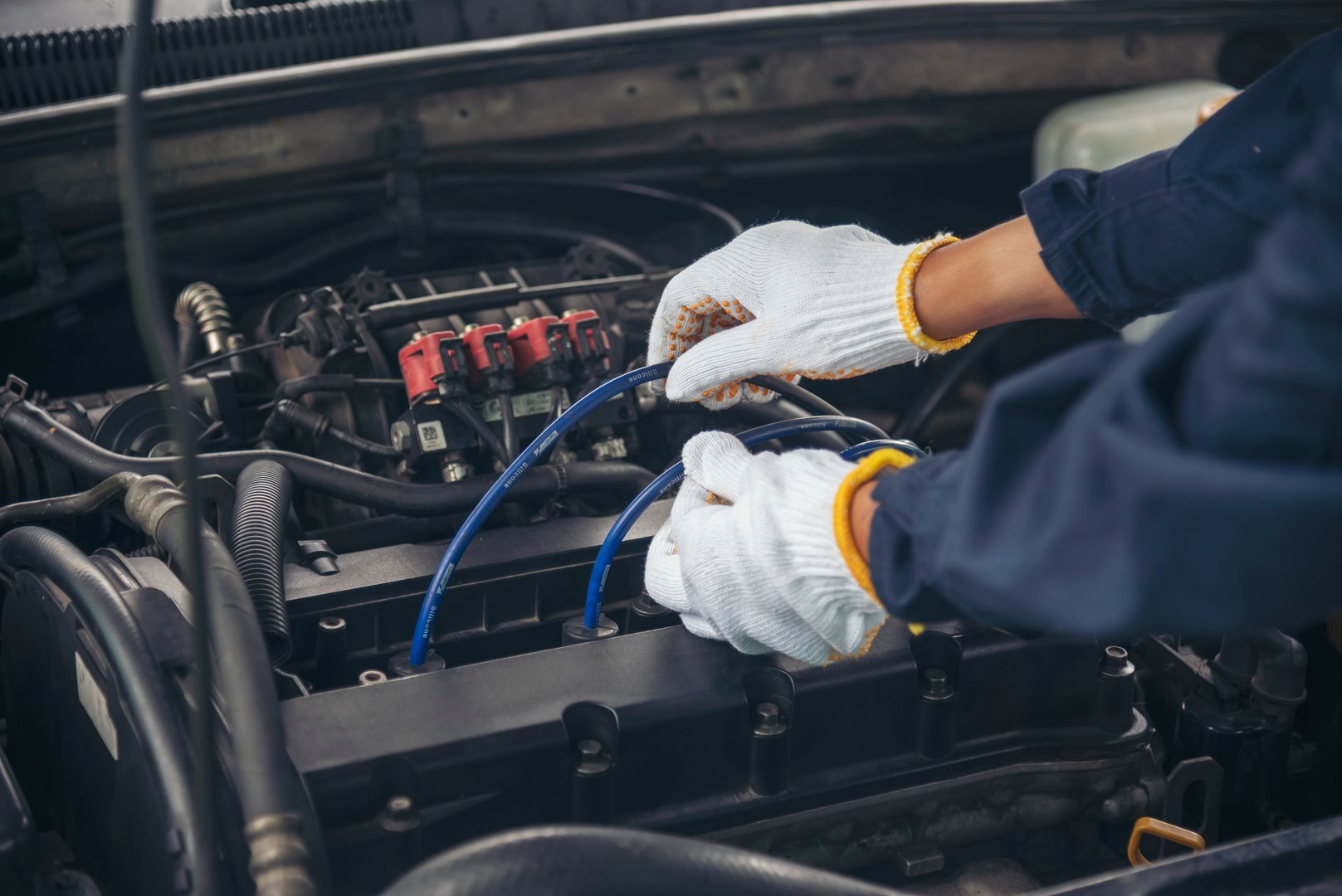 Close up Car Mechanic man hands repairing car auto repair shop. Man hands fixing machinery vehicle mechanical service. open vehicle hood checking up auto mobile. Vehicle Car maintenance engineer.