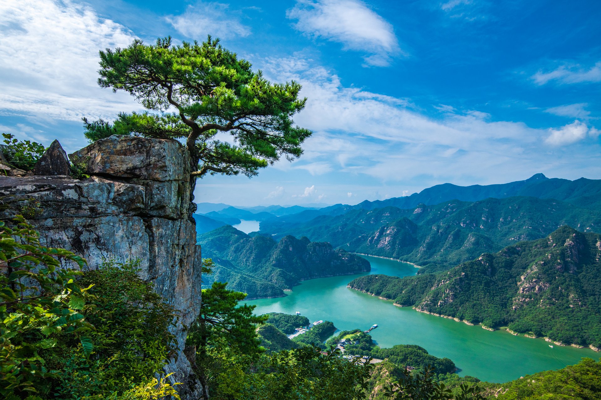 Trees stand on the rocks, Mount Chiang, there is an emerald green river, South Korea, the sky is bright and beautiful.