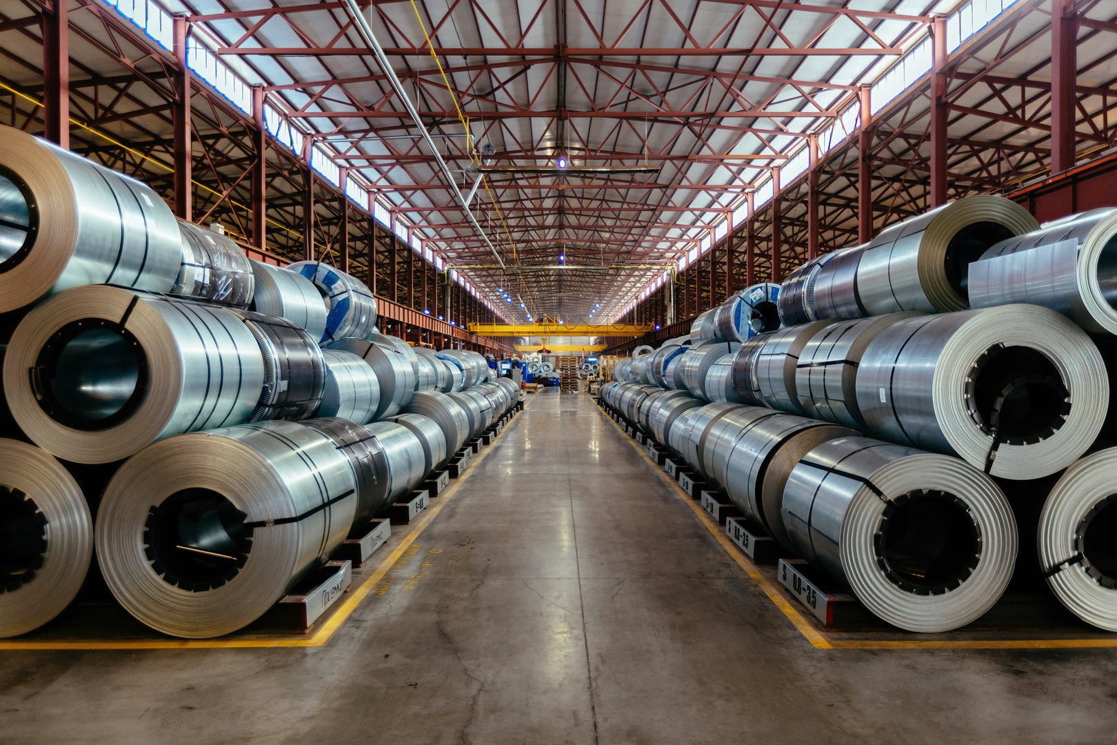 Rolls of galvanized steel sheet inside the factory or warehouse.