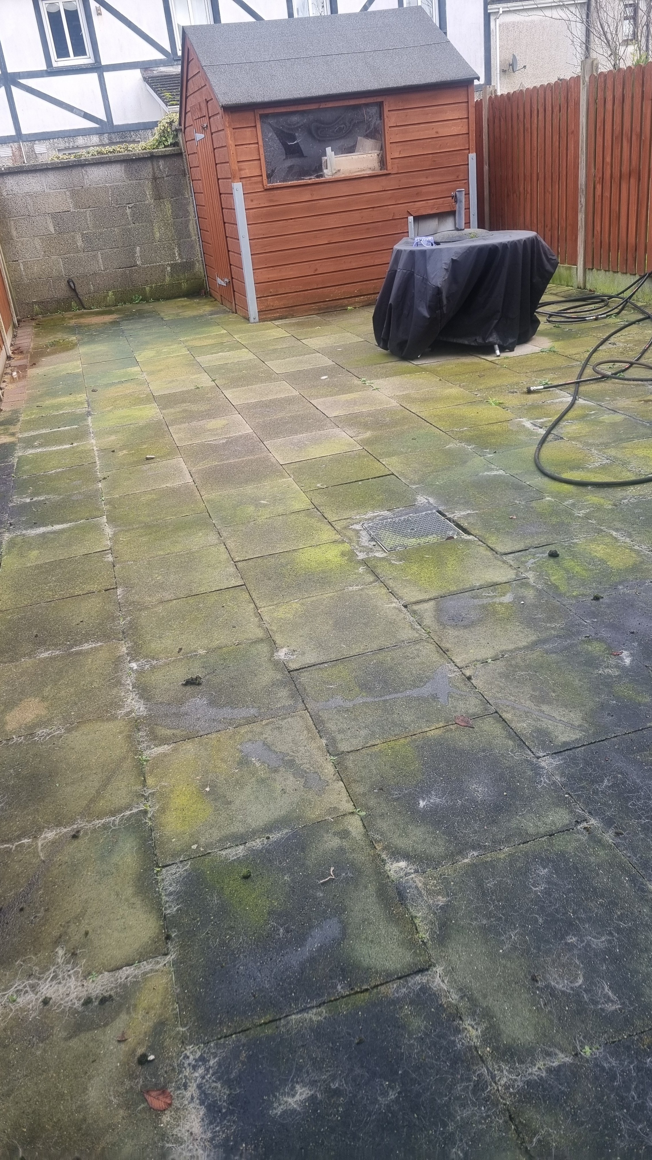 Before pressure washing showing dirty garden patio