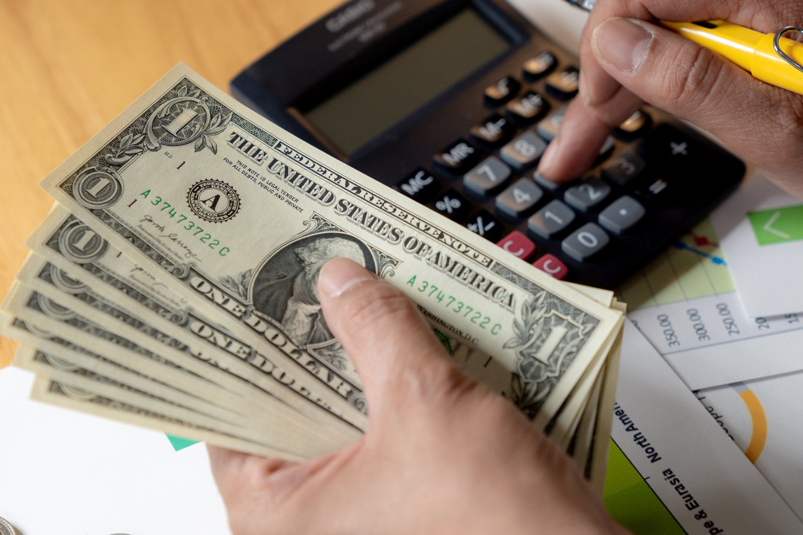 Financial planning in action, alculating expenses while handling cash