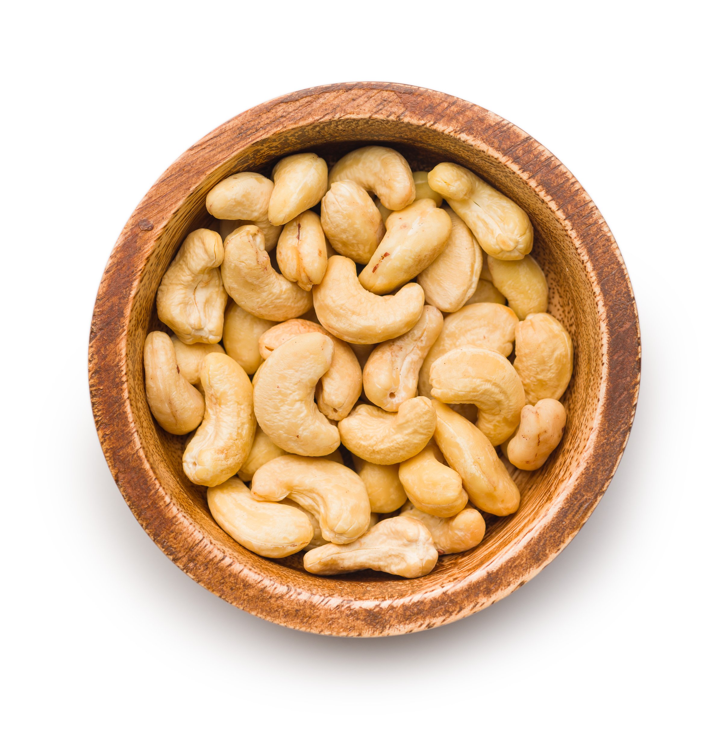 Roasted cashew nuts in bowl isolated on a white background.