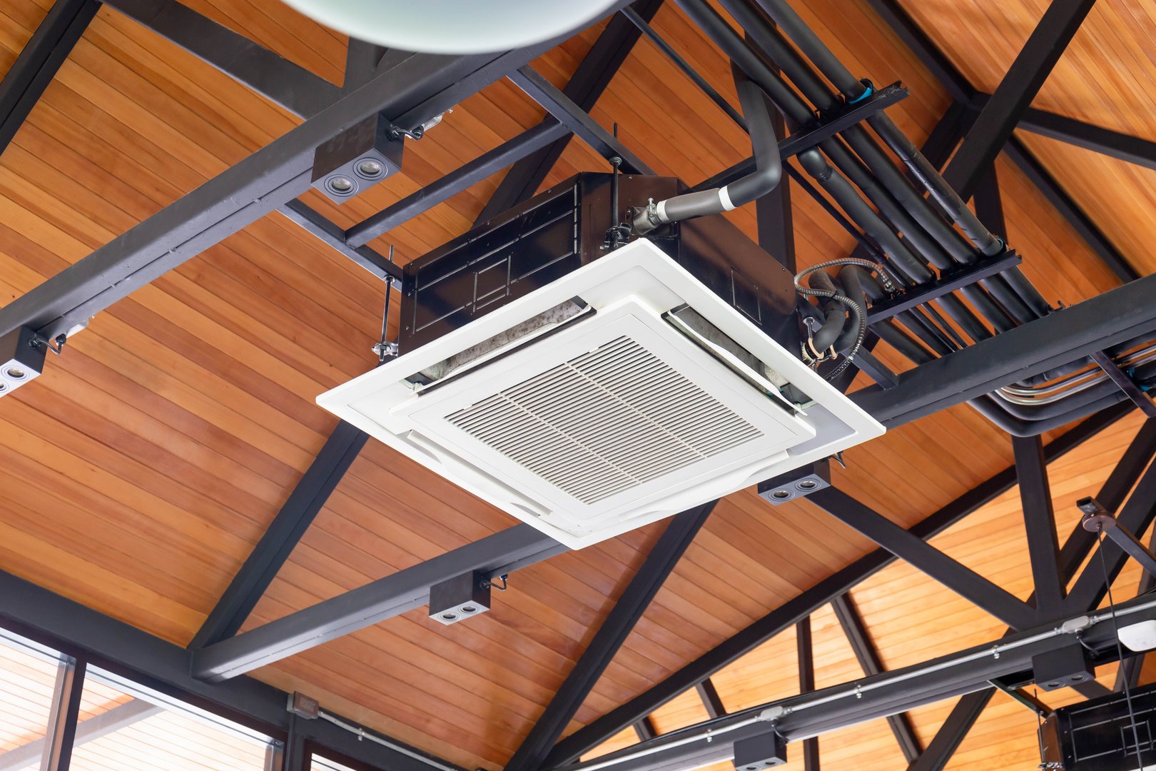 Modern ceiling mounted cassette type air conditioning system in coffee shop