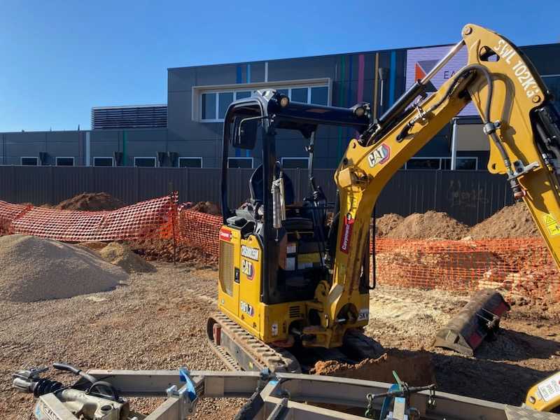 Excavator at civil plumbing construction site