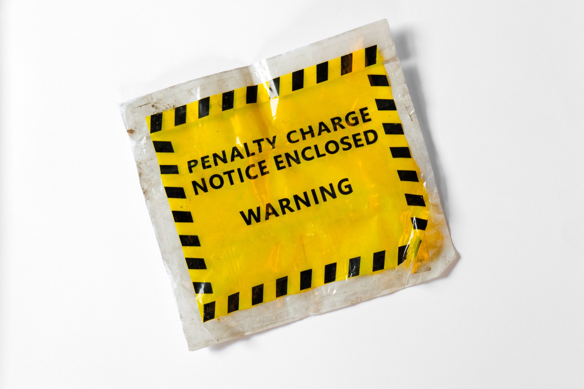 Yellow penalty charge notice envelope in bright yellow