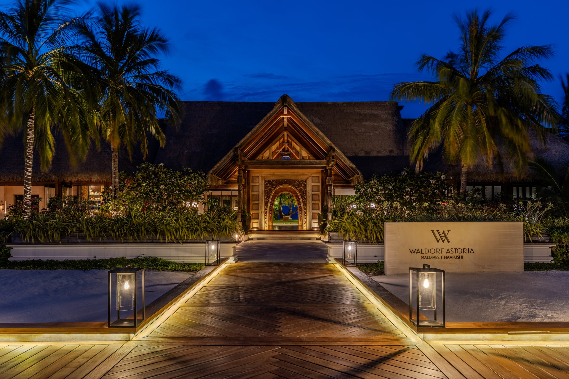 Maldives - May 6, 2025:  A beautiful view of the arrival area leading to the lobby of Waldorf Astoria Maldives Ithaafushi luxury resort during blue hour after sunset.  HDR encoded