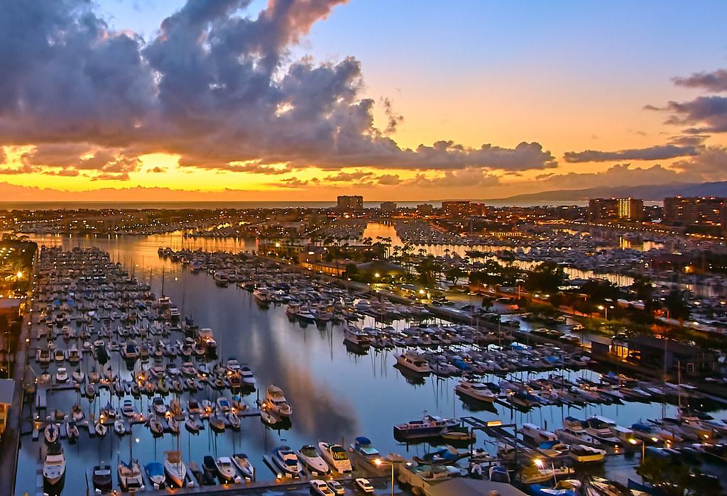Boats and yachts docked in Marina del Rey Harbor surrounded by waterfront condominiums and marina docks in Los Angeles.