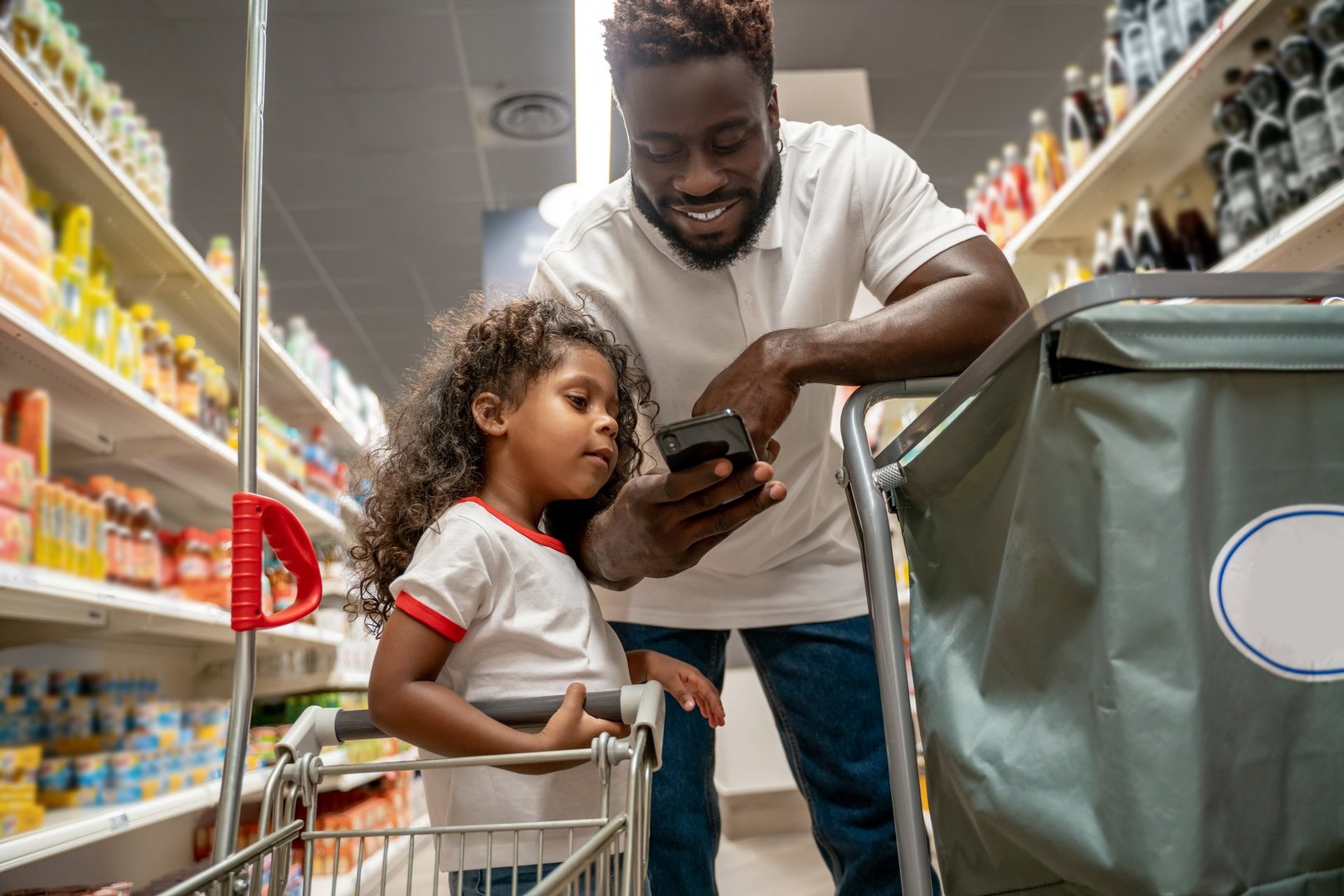 Food shopping. Man and his daughter on a food shopping