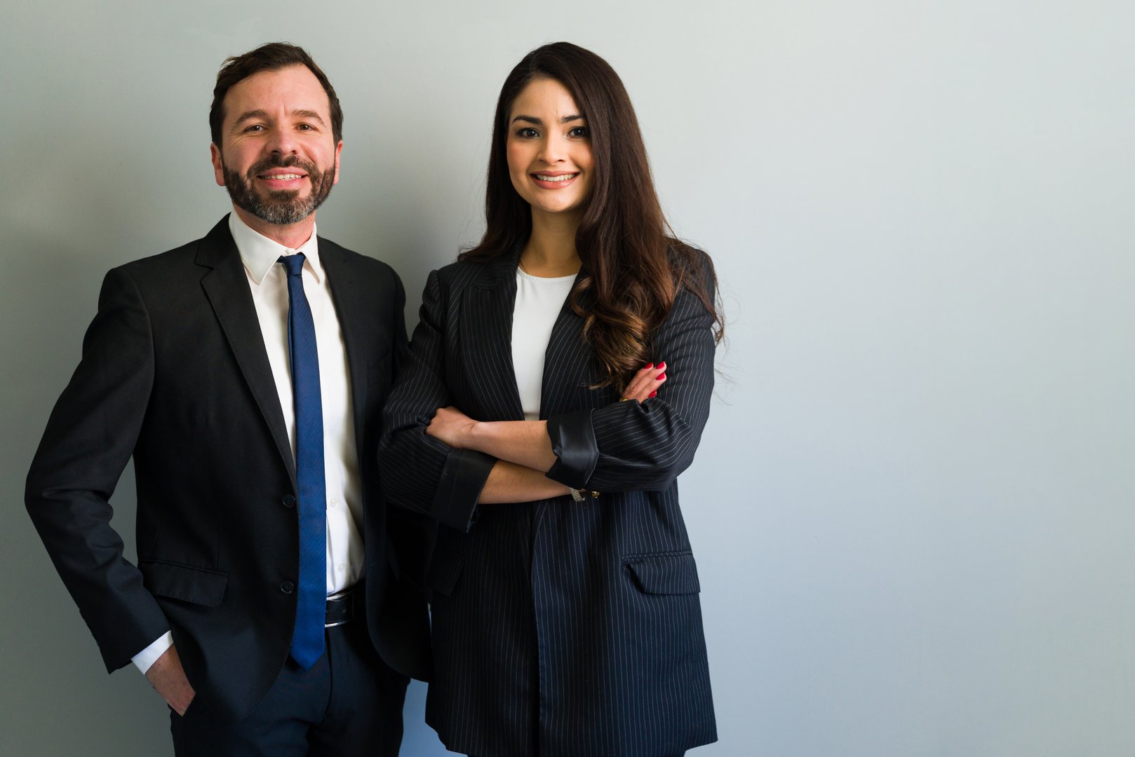Cheerful businessman and businesswoman wearing formal clothes