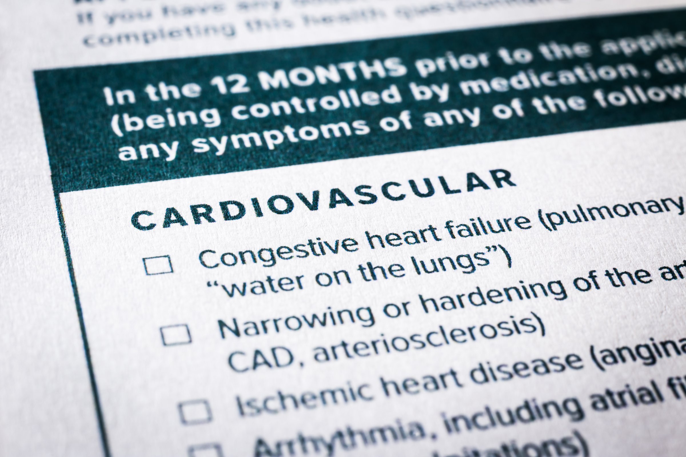 Close up image, selective focus on cardiovascular, heart disease content on health insurance questionnaire and application form. Healthcare, insurance policy, personal safety plan, business concepts.
