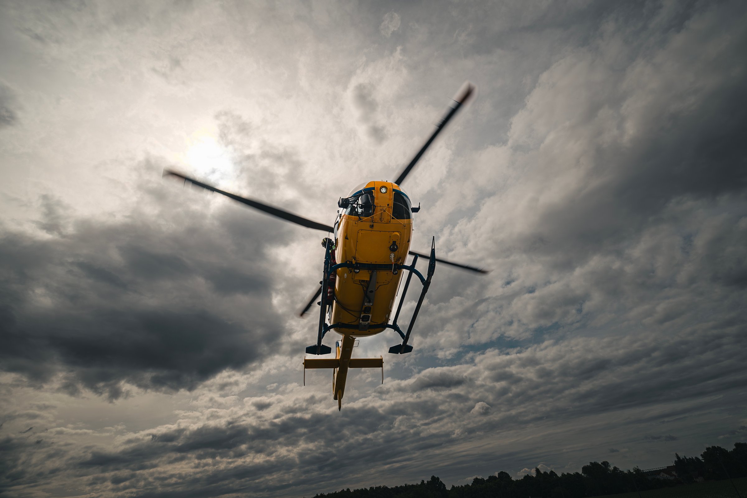 Flying yellow helicopter of emergency medical service. Themes rescue, help and hope.