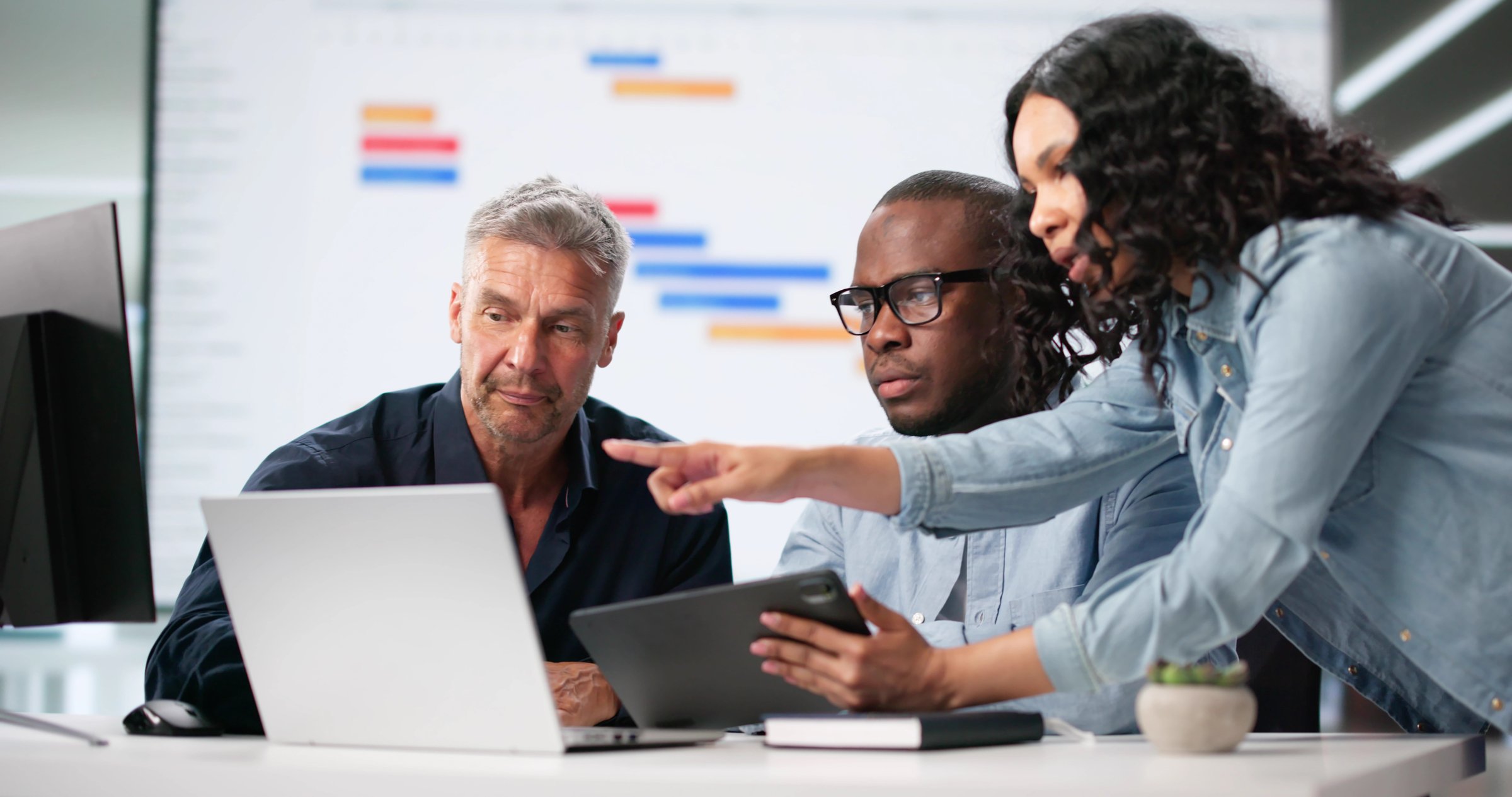 Diverse Corporate Team Using Gantt And Kanban Boards For Project Management. Man And Woman Work Together In Office