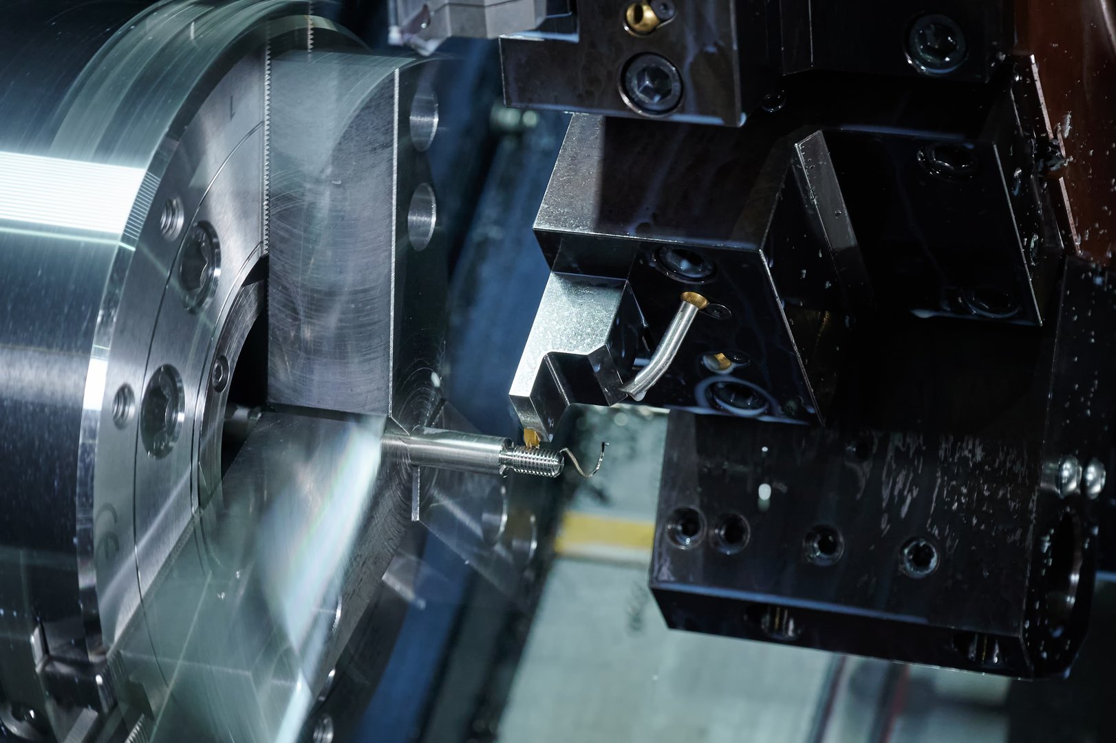 Close-up of a CNC milling machine drilling holes. Selective focus.