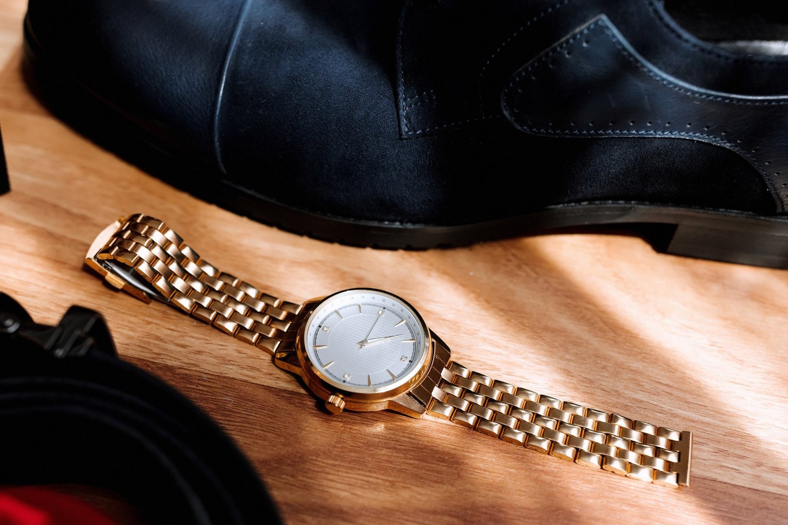 Gold watch on wooden table