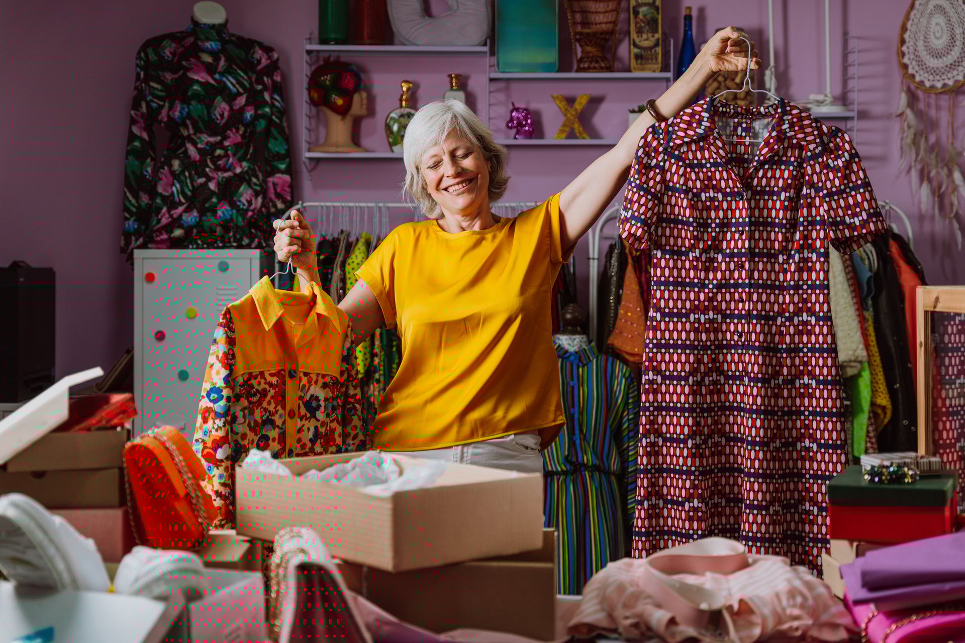 Senior woman selling clothes and accessories online. Managing a Small business during the seniority period. Listing articles and products to sell on the selling  platforms.