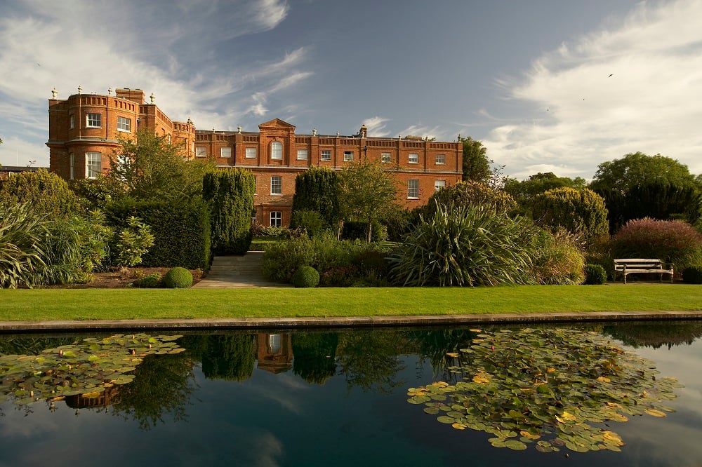 The Grove Mansion House across lily pad covered canal historic estate