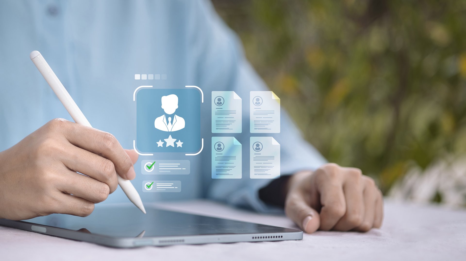 Hand using stylus on tablet with digital resume and candidate profile interface, concept of online hiring and HR technology.