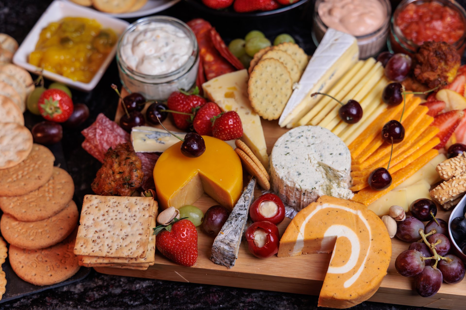 Cheeseboard Selection with Fruit and Snacks close up