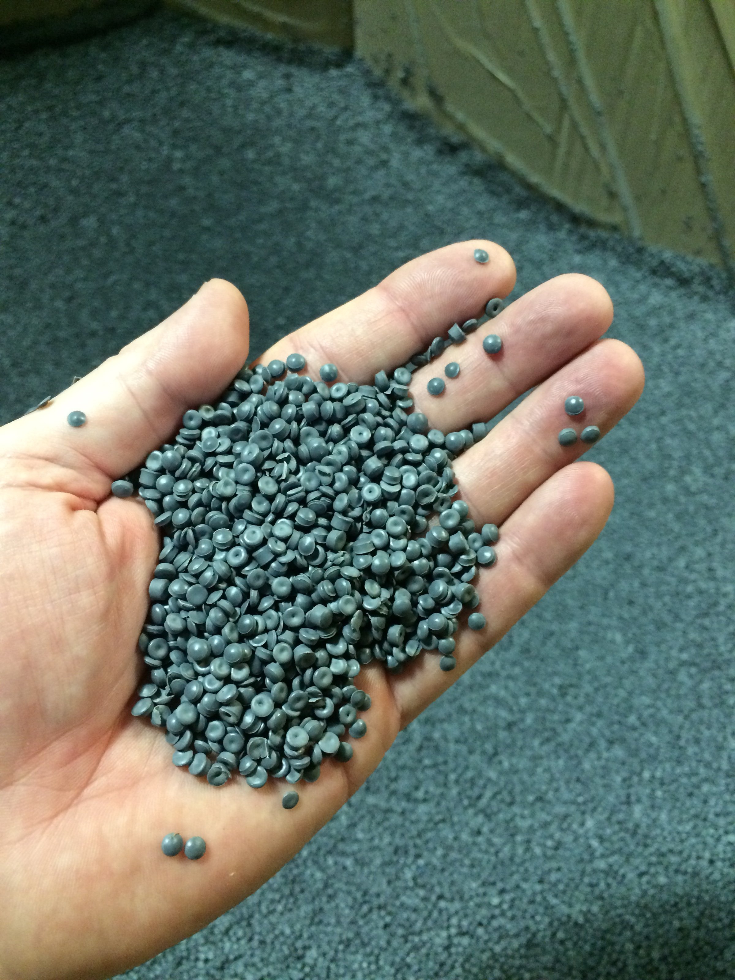 Hand cupping polyethylene recycled resin in a gaylord container