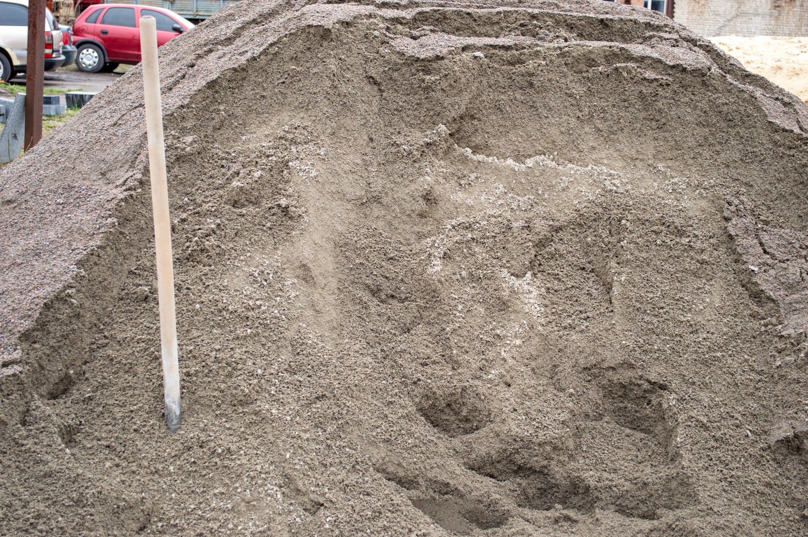 A large pile of sand sits at a construction site