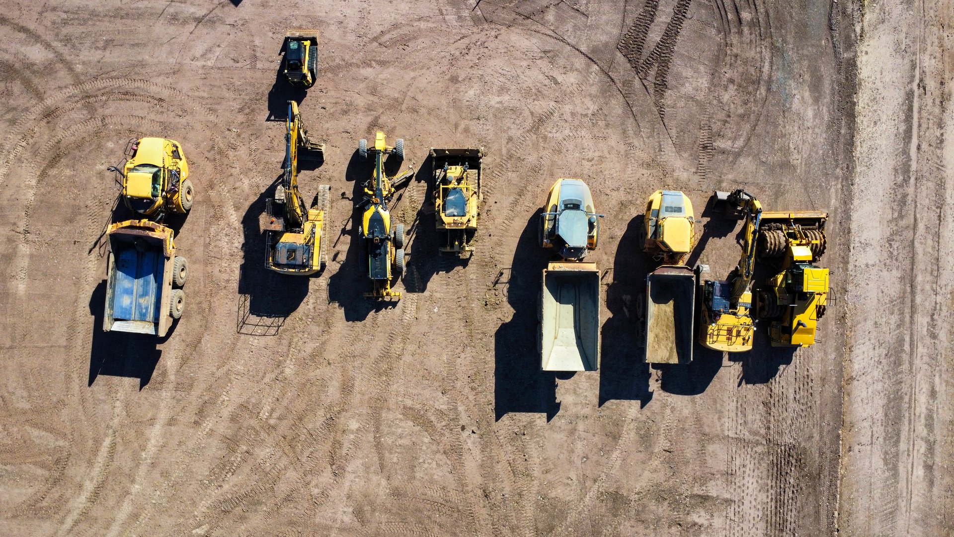 a construction site with parked machines, photograped with a drone