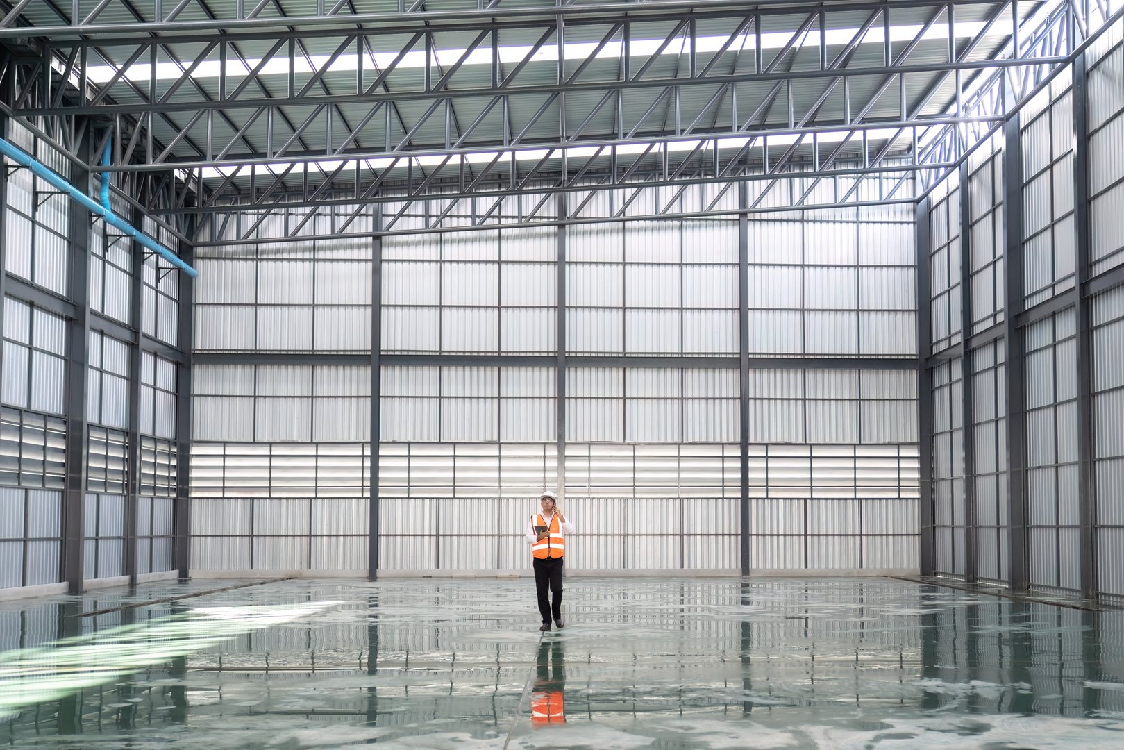 Interior of empty warehouse with worker. Warehouse industry concept