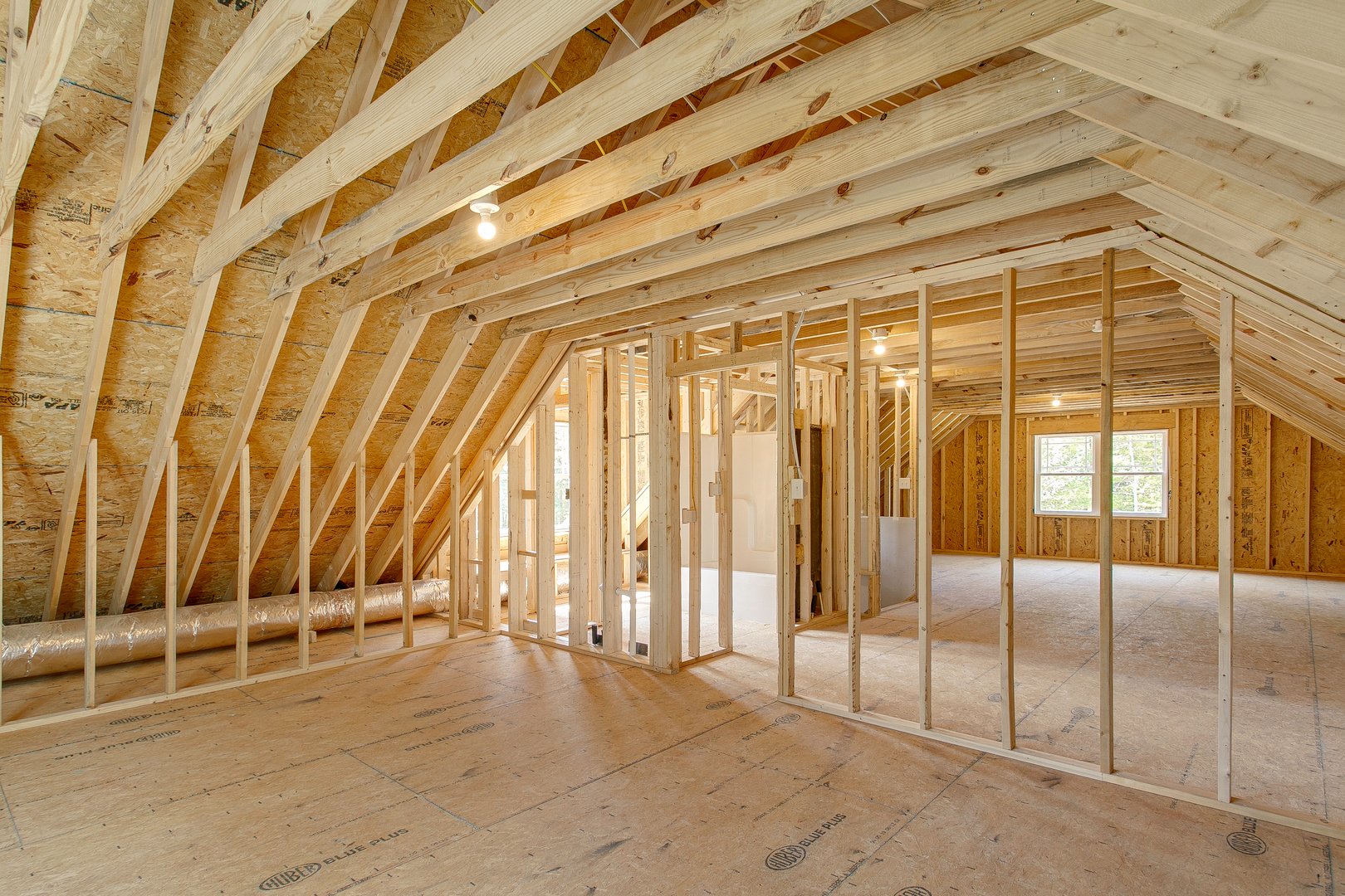 An unfinished attic space highlighting wooden framing and open design, offering potential for customization in construction projects or home renovations.