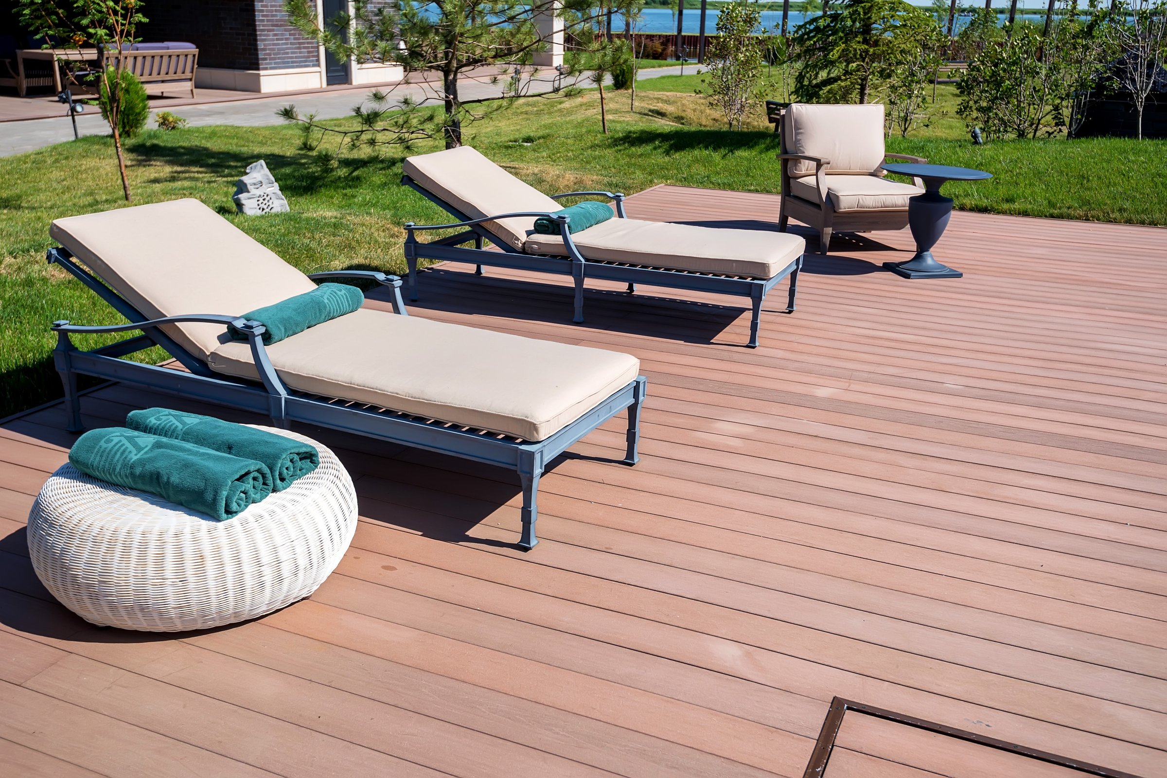 Deck chairs near the swimming pool with beautiful blue water
