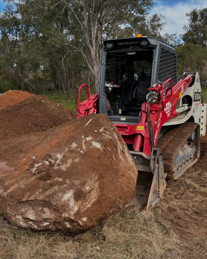 Takeuchi excavator machine in action at a construction site