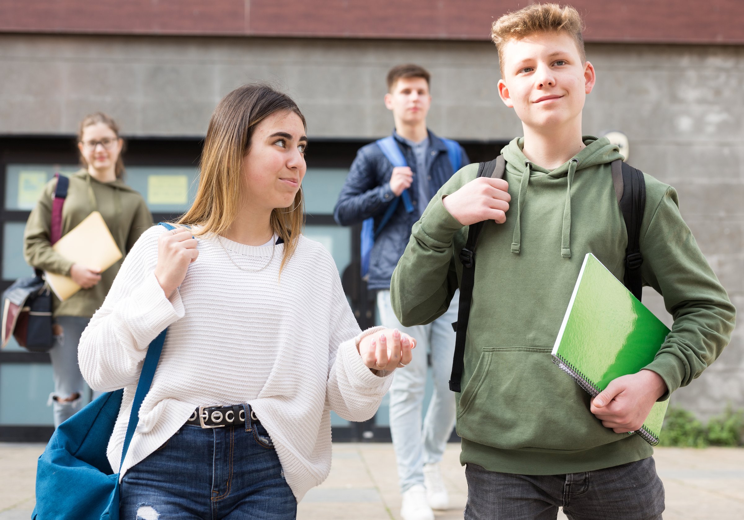 Guy and girl are walking carelessly down the street