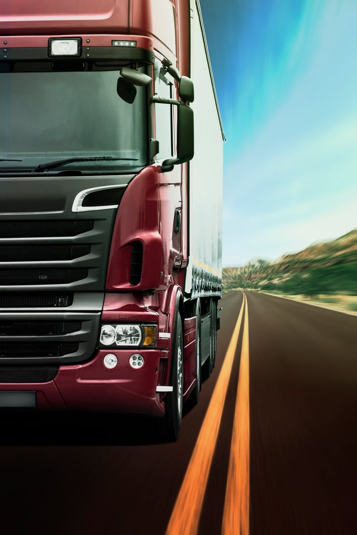 Showing a kind of a road haulage and logistics. Tractor unit pulling a semi-trailer through a beautiful landscape.