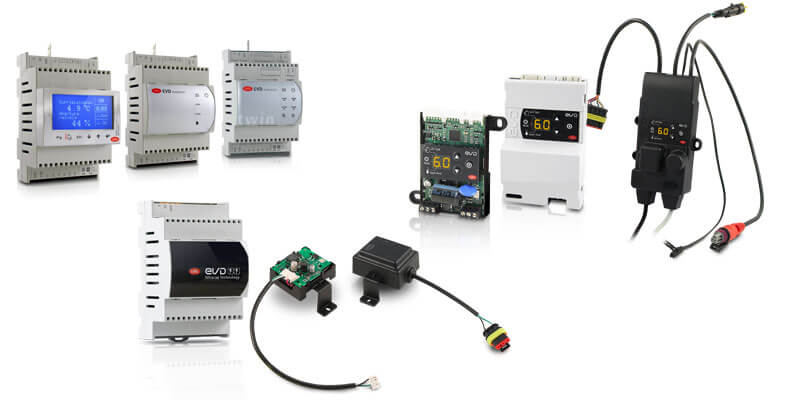Various electronic industrial control devices displayed, including programmable controllers and circuit boards.