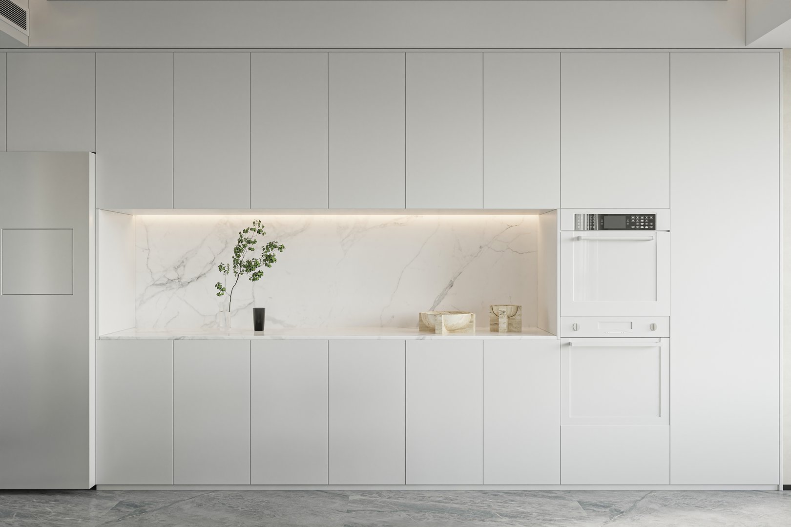 Sleek white kitchen with integrated appliances, marble backsplash, and subtle lighting
