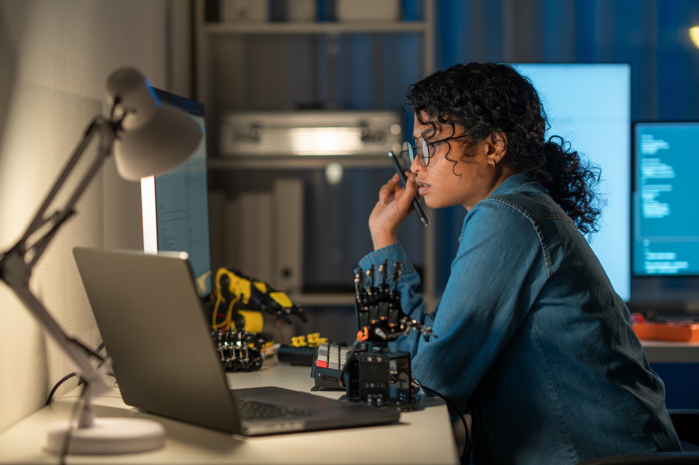 Robotics engineer using advanced coding to innovate new solutions. Explore the synergy of AI and robotics in technology today.