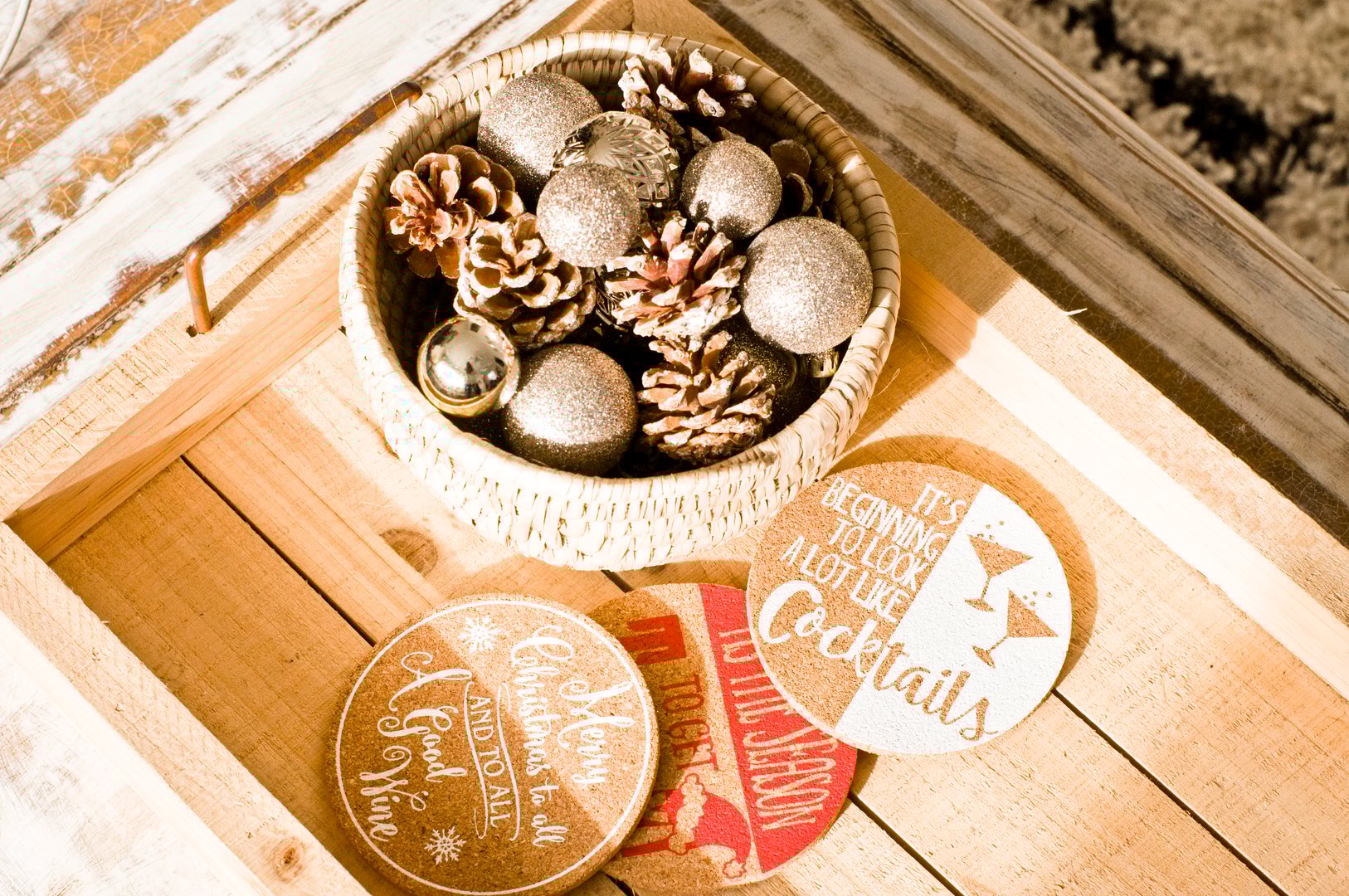 Holiday-themed coasters and ornaments displayed together