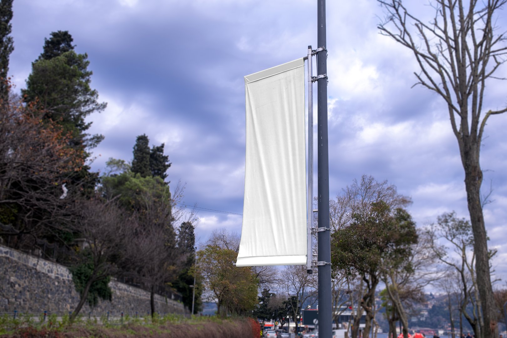 An advertising pole banner mockup on street. White banner.