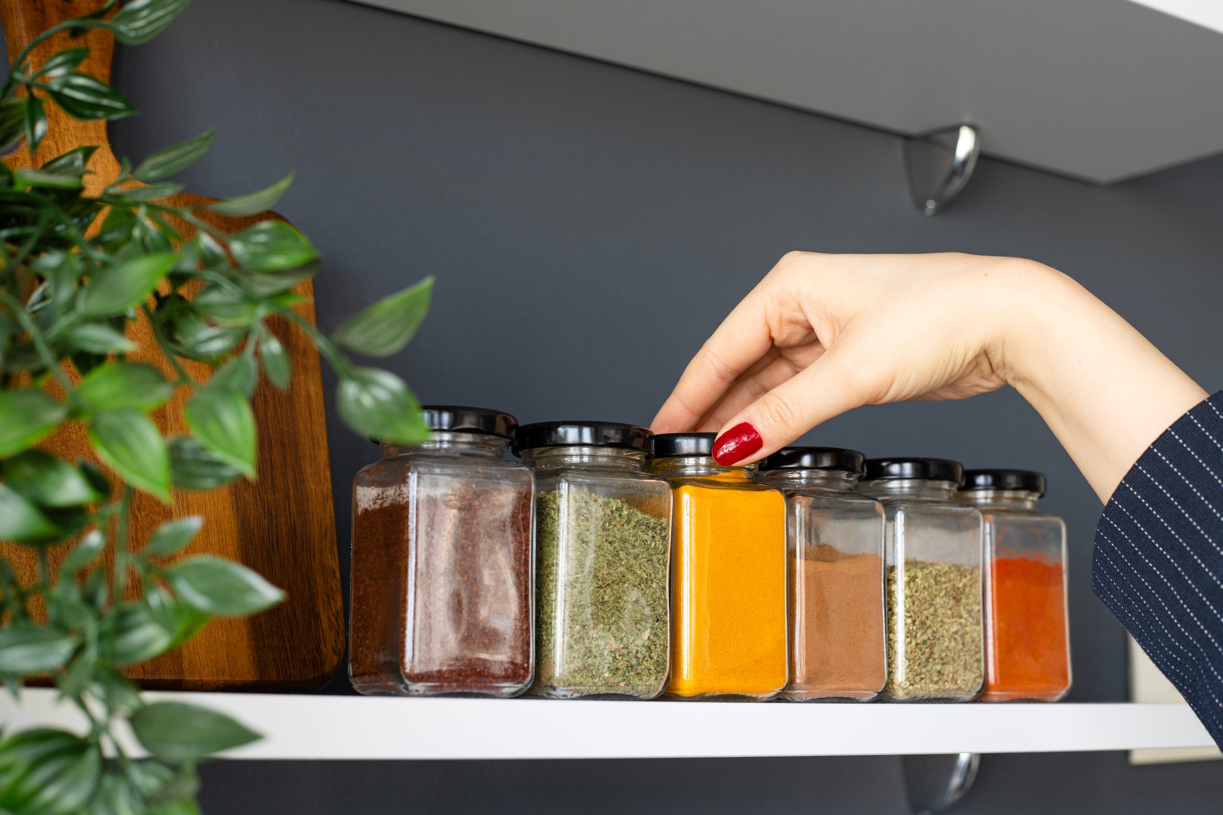 Hand holding jar of spices