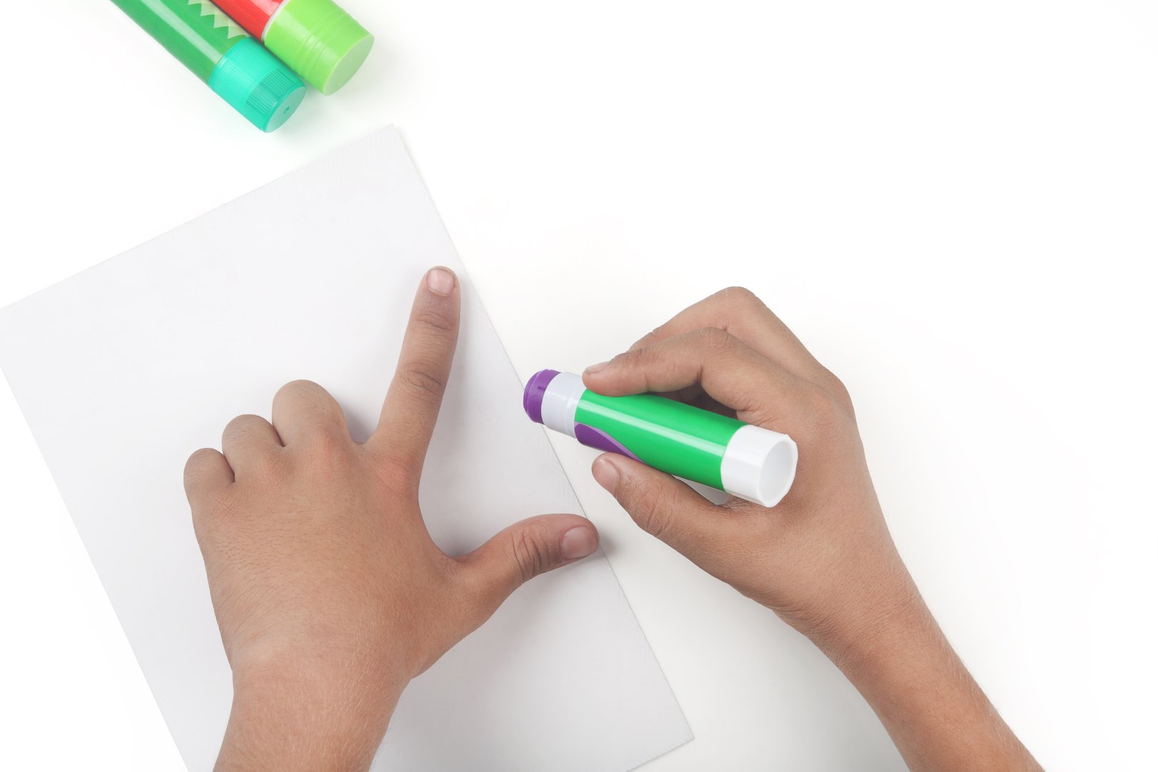 Glue Stick with Hand on White Background