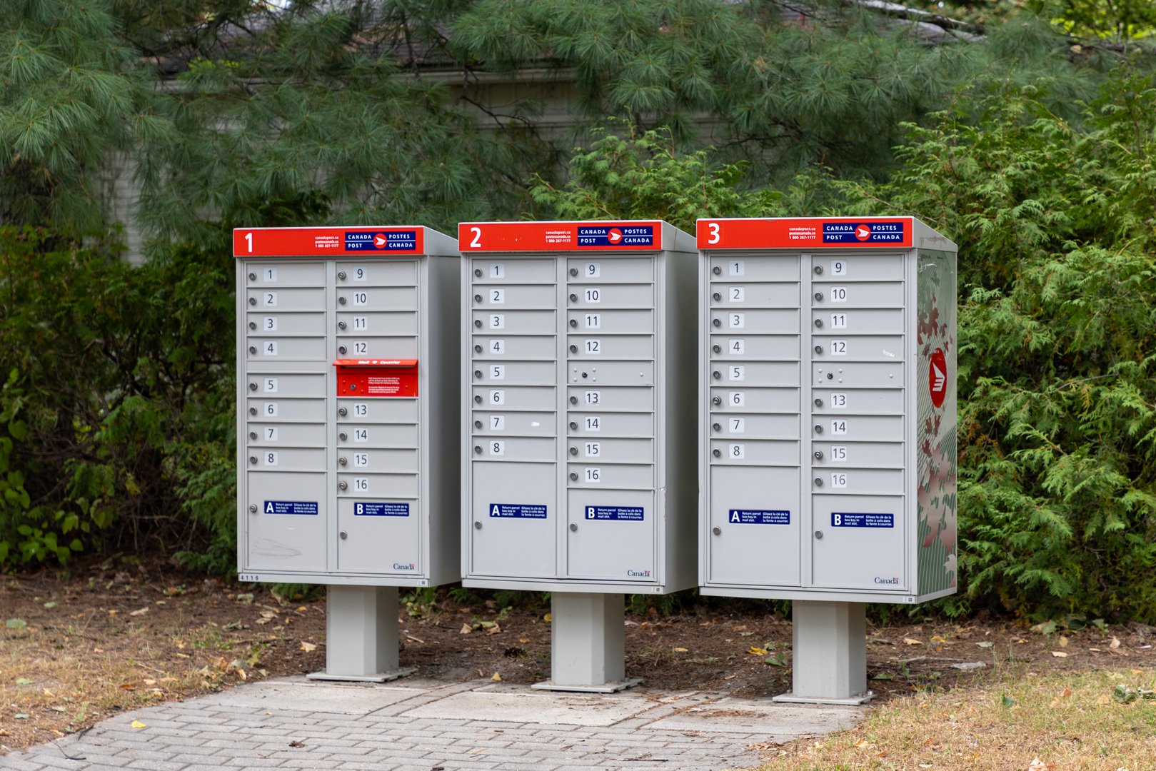 Ottawa, Canada - September 24, 2024: Canada Post mail boxes in a neighborhood community with red sign in English and French