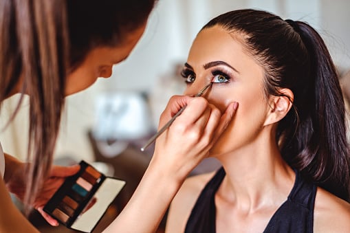 Professional makeup artist applying makeup for special event