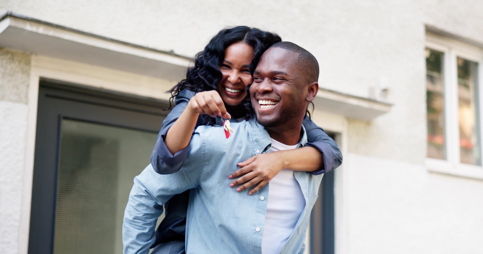 Newly Married Couple Celebrates Buying First Home, Holding Shiny Keys.