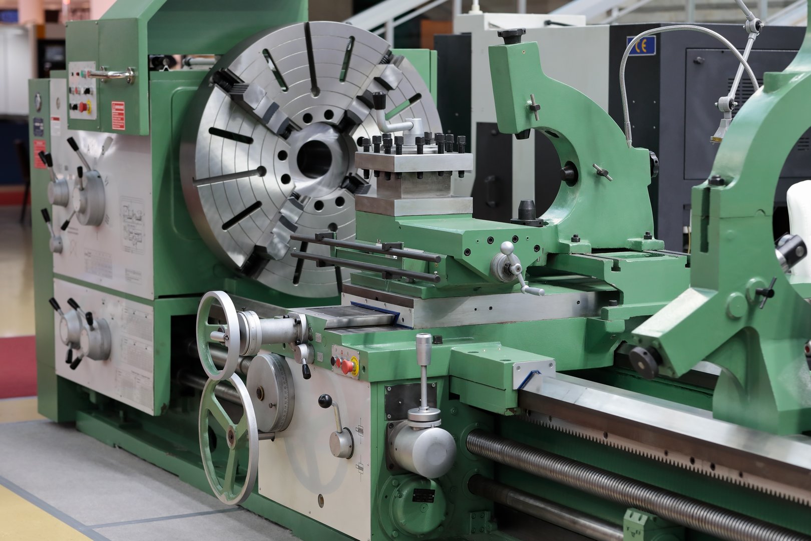 Big bore heavy duty conventional metal lathe is used to process workpieces with large turning diameters and lengths. Selective focus.