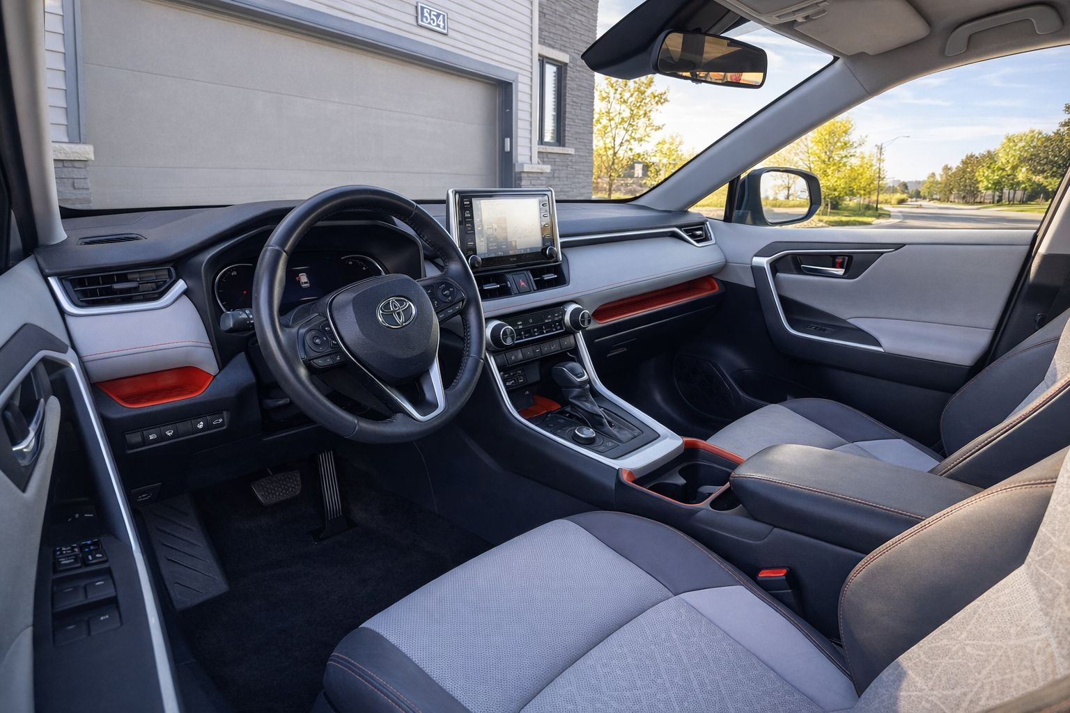 Car wash or detailing studio employee applies ceramic or graphene coating to black car paint ensuring deep gloss and advanced protection