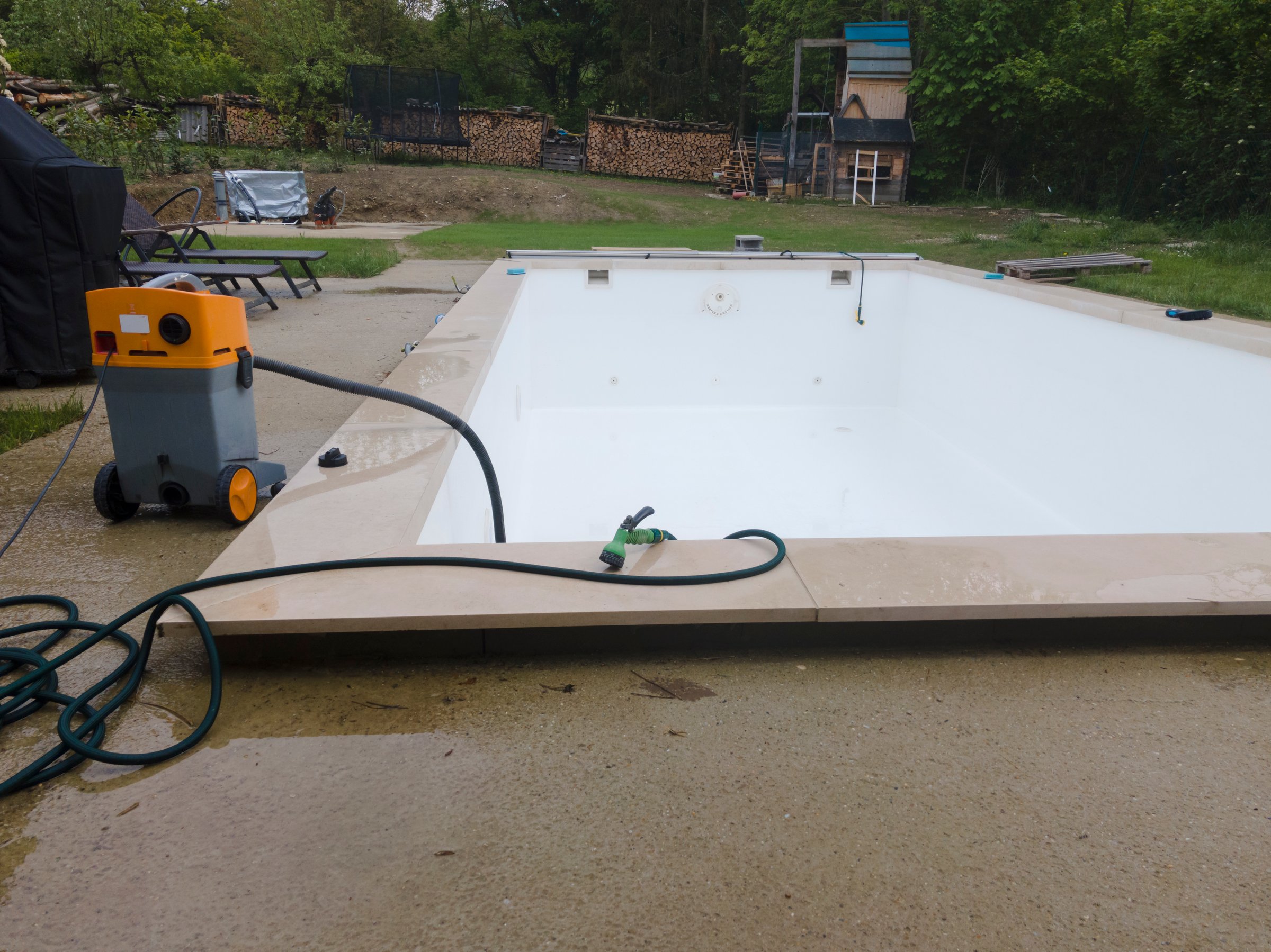 Drone flight over pool in the middle of greenery just left out and cleaned