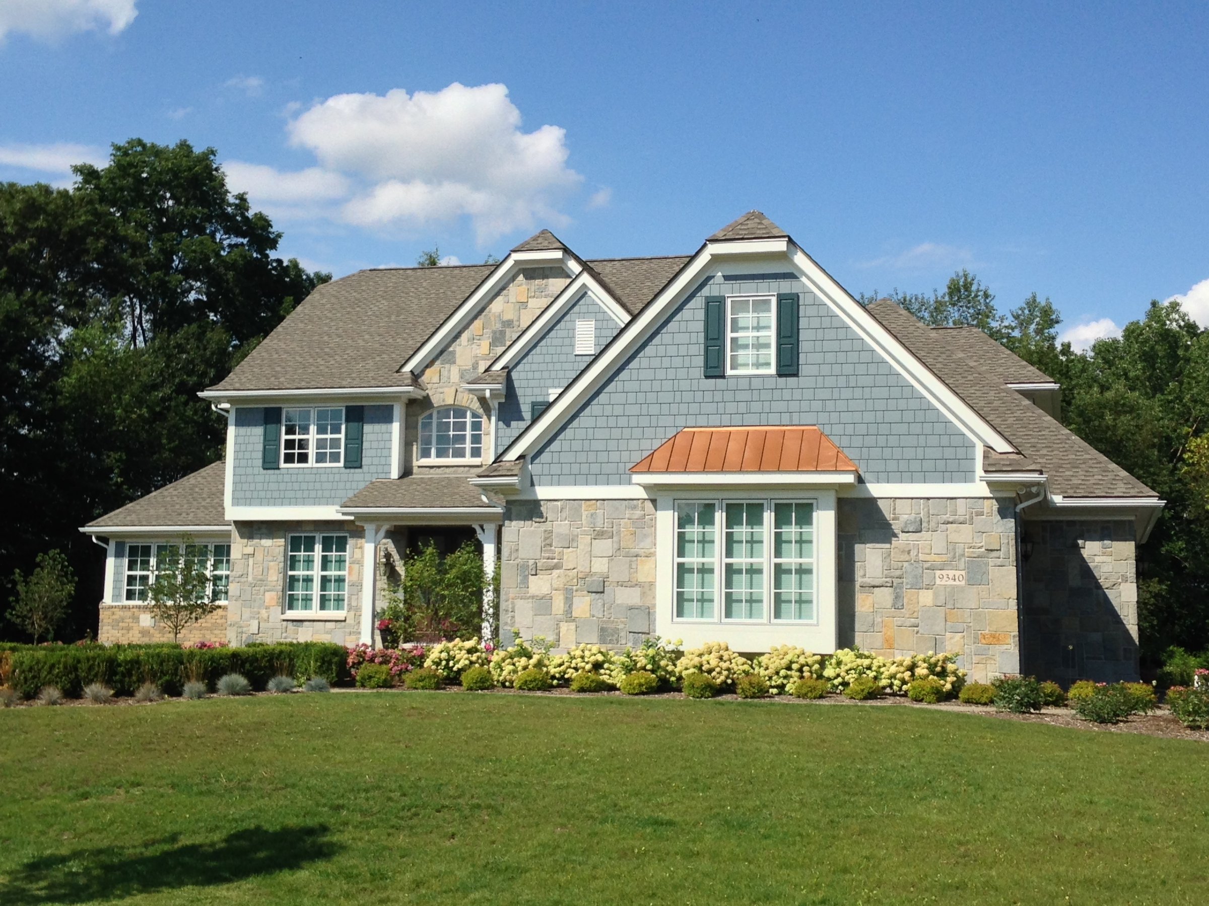 Two-story home with blue siding.