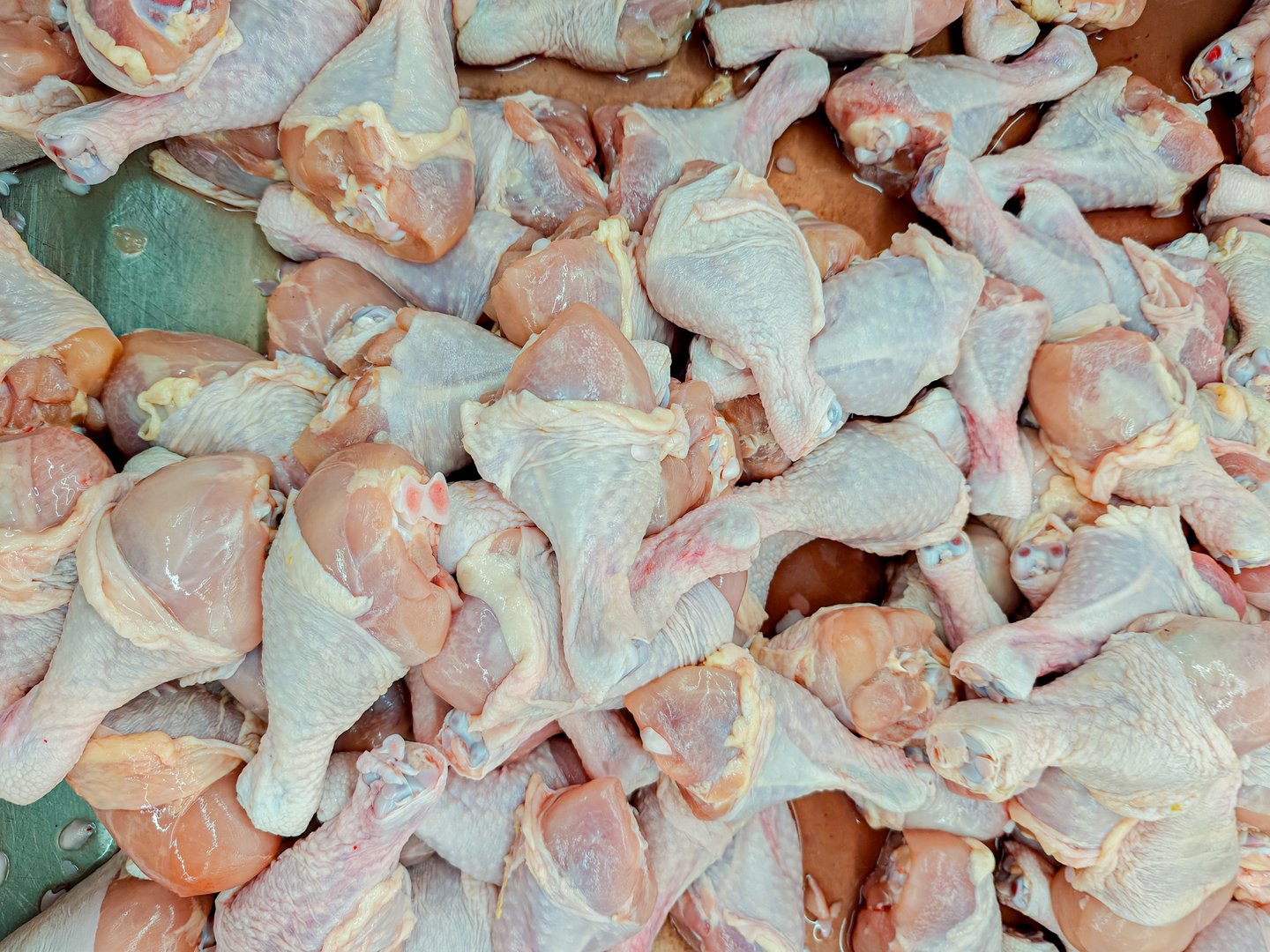 Fresh Raw Chicken wing pieces on cool Tray at Local Market Used for cooking