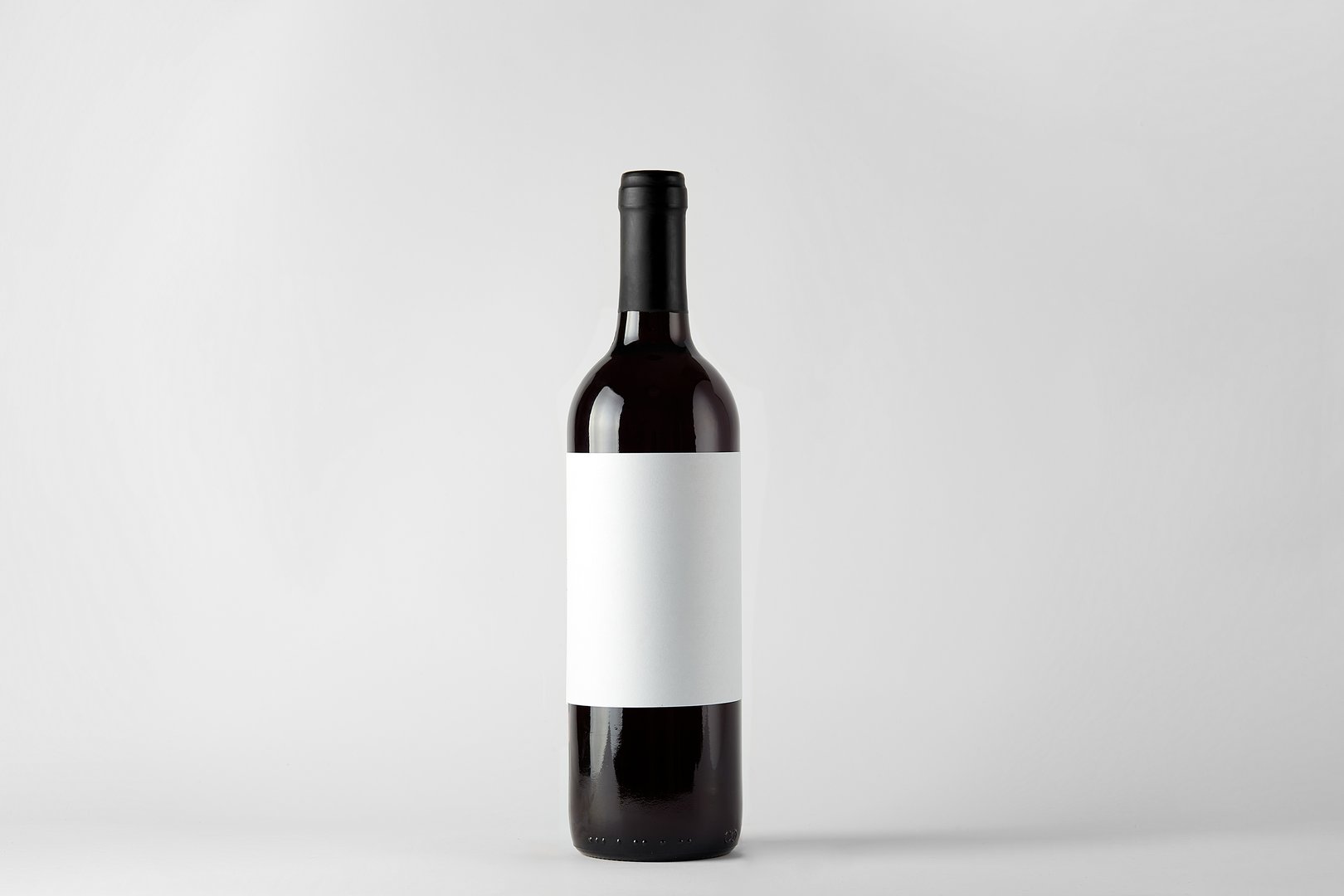 Black wine bottle with red wine isolated on white
