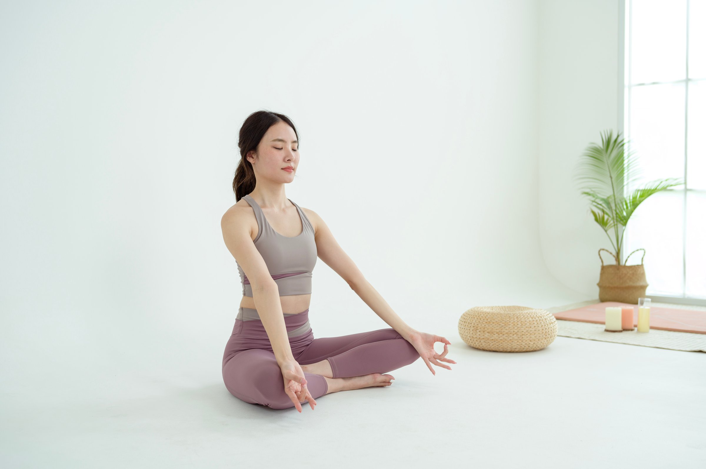 Asian woman in sportswear exercising and doing yoga