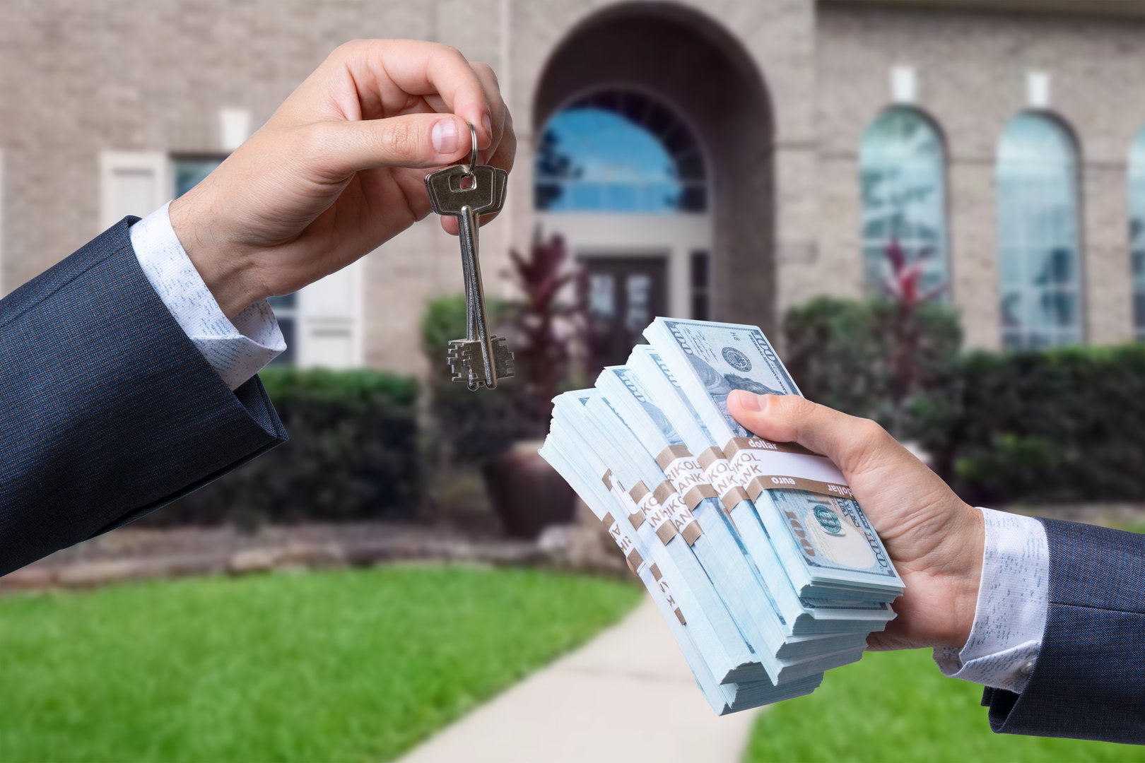 Man Handing a man Thousands of Dollars For Keys in Front of House