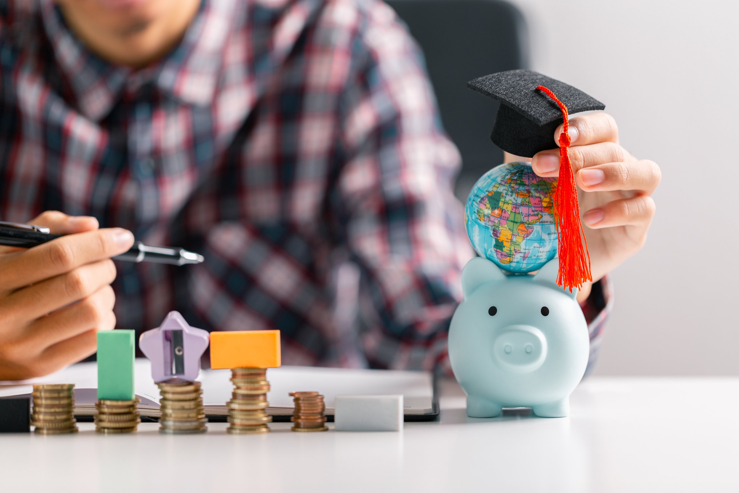 University graduate, holding their diploma and wearing cap and gown, celebrates their education with sense of accomplishment, ready to take on world. diverse, exchange, multicultural, foreign, learn